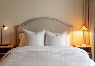 Serene bedroom with a made bed and warm lighting